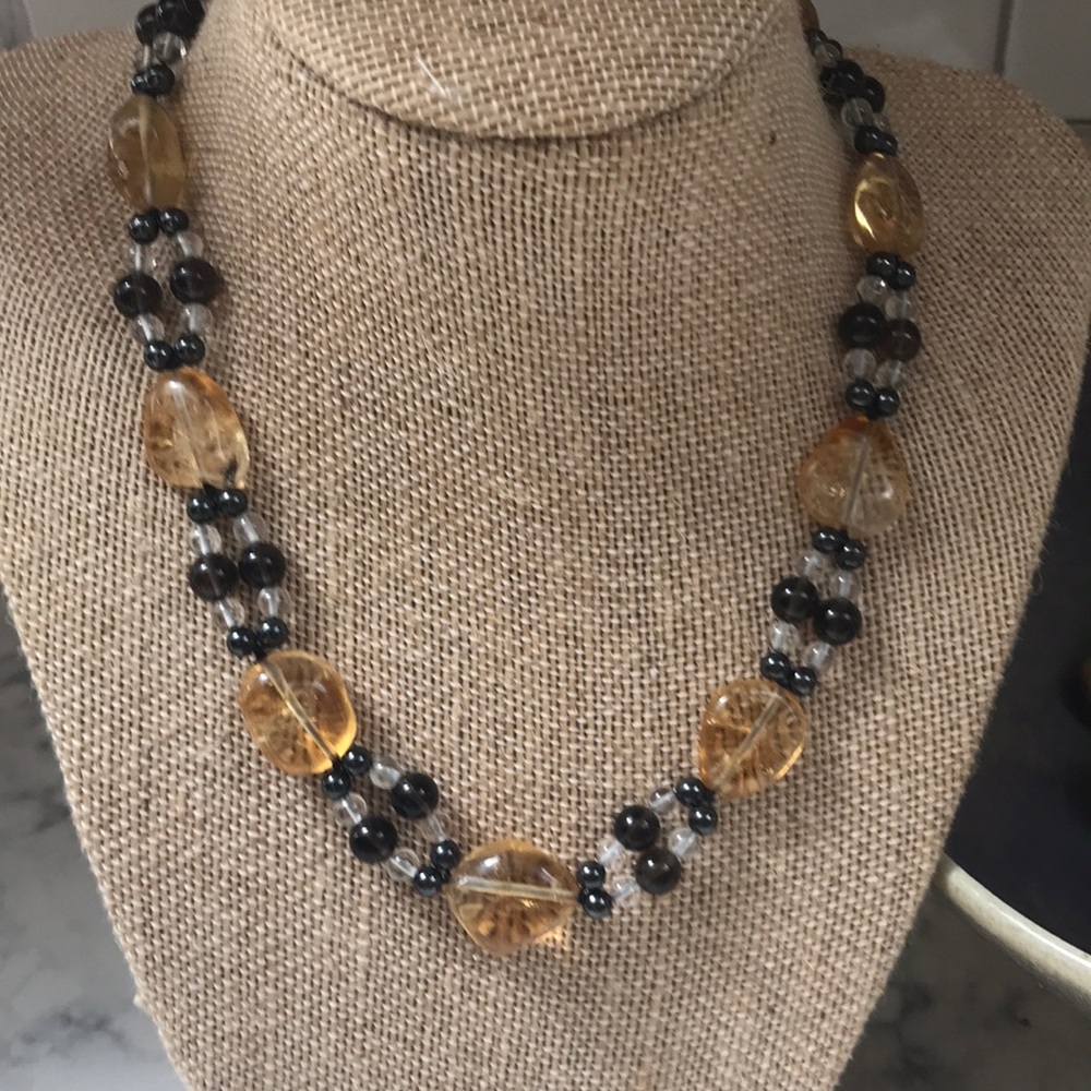 Citrine surrounded by smoky topaz, aqua marine, and hematite